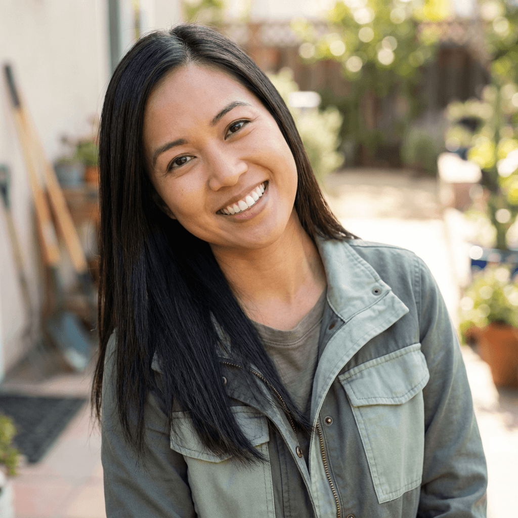 Lyndsey Freeman in a Tidy Touch Cleaning Company shirt holding a microfiber cloth
